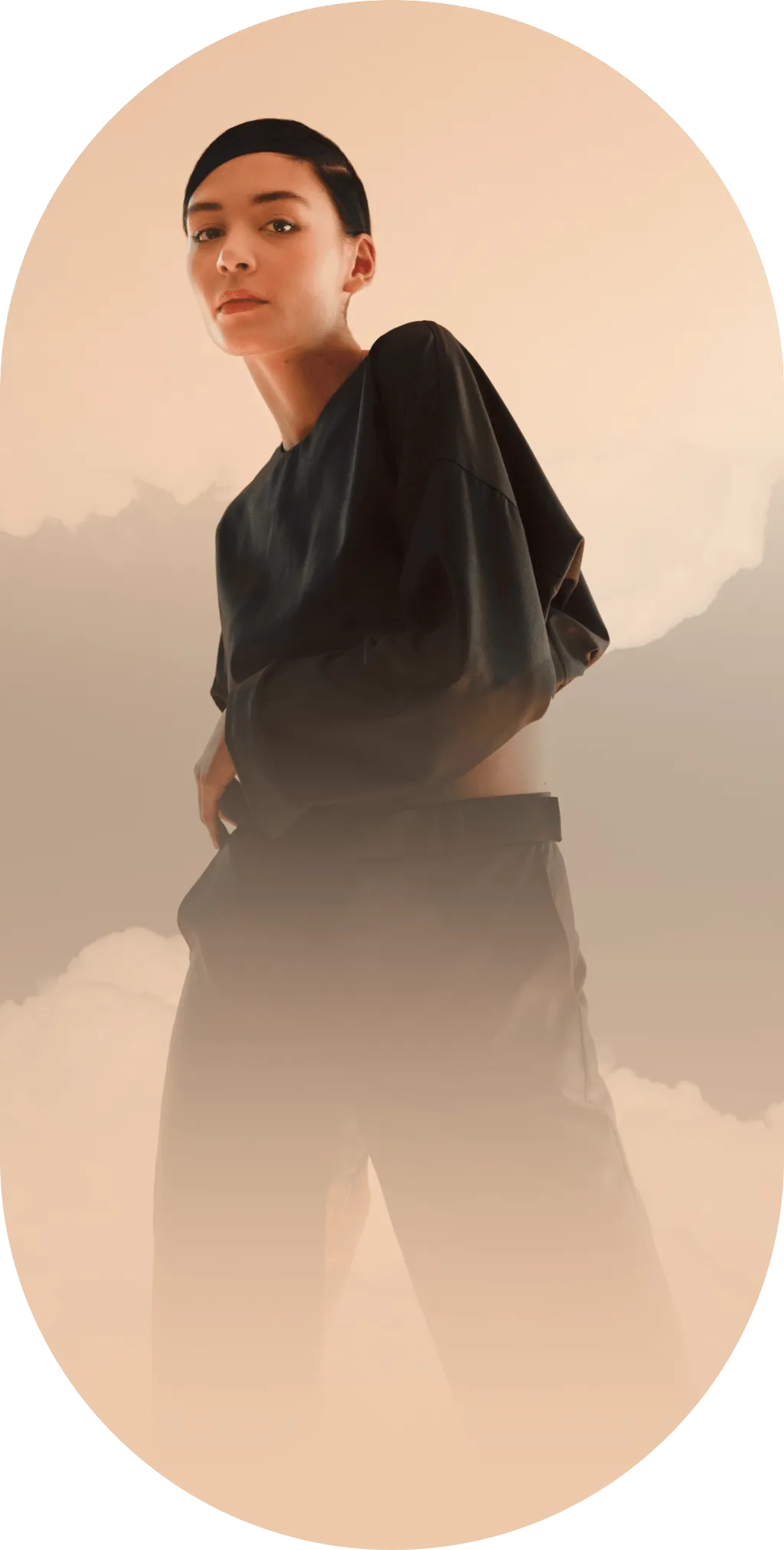 person standing amongst clouds on beige background